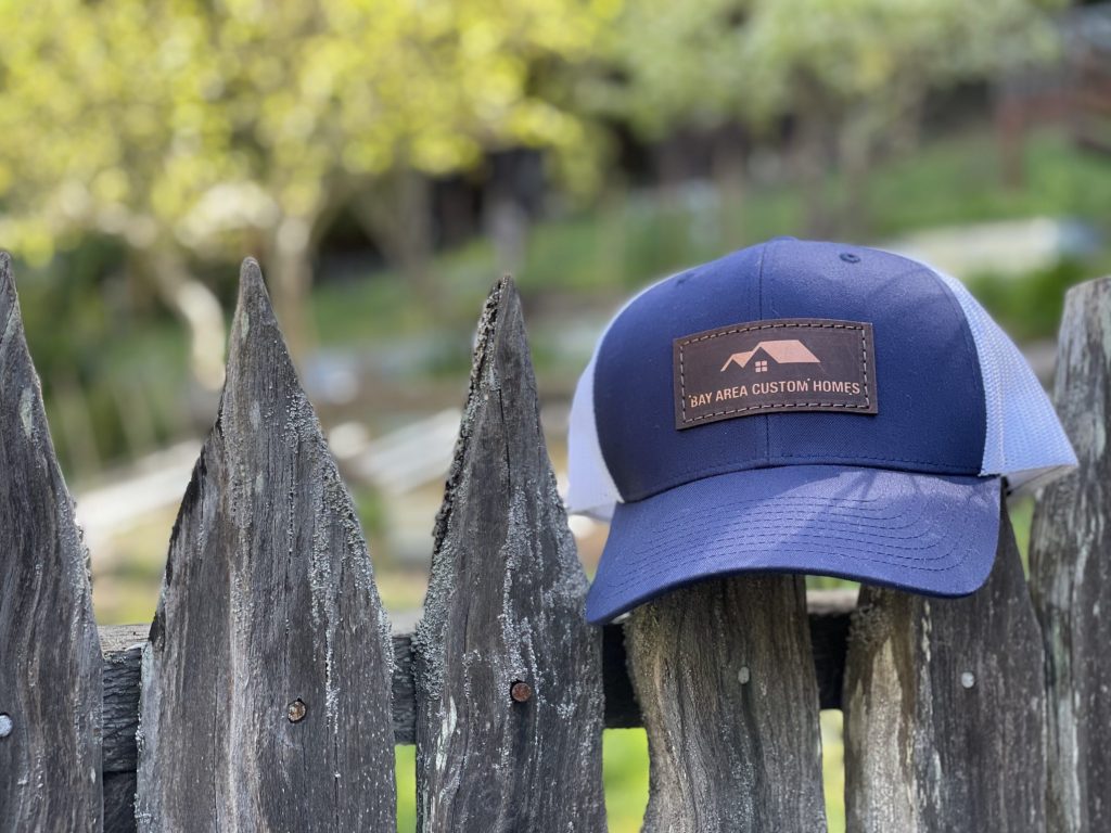 leather patch hat on a fence