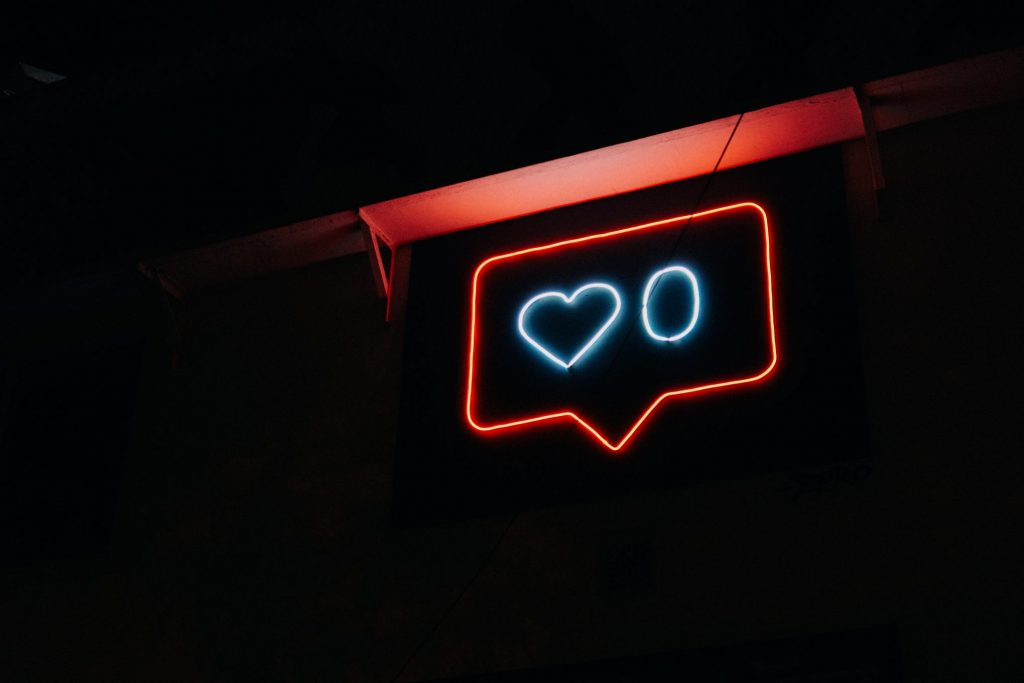 a neon sign showing an instagram notification
