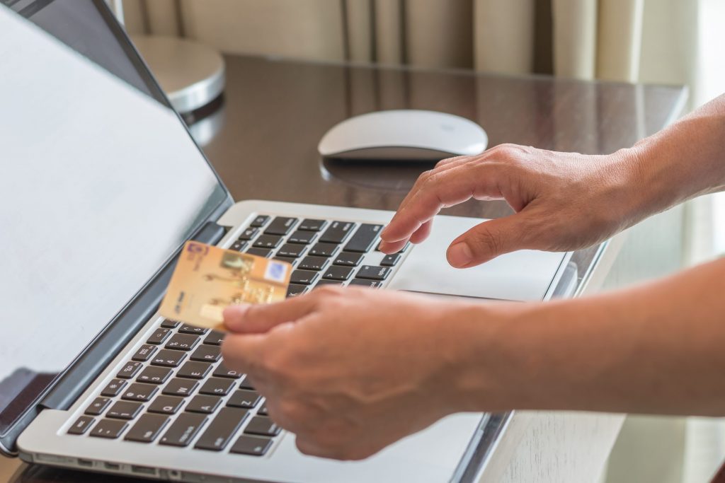 someone entering credit card information into a computer