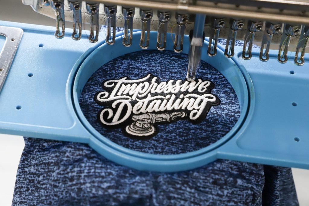 A logo being embroidered onto a shirt