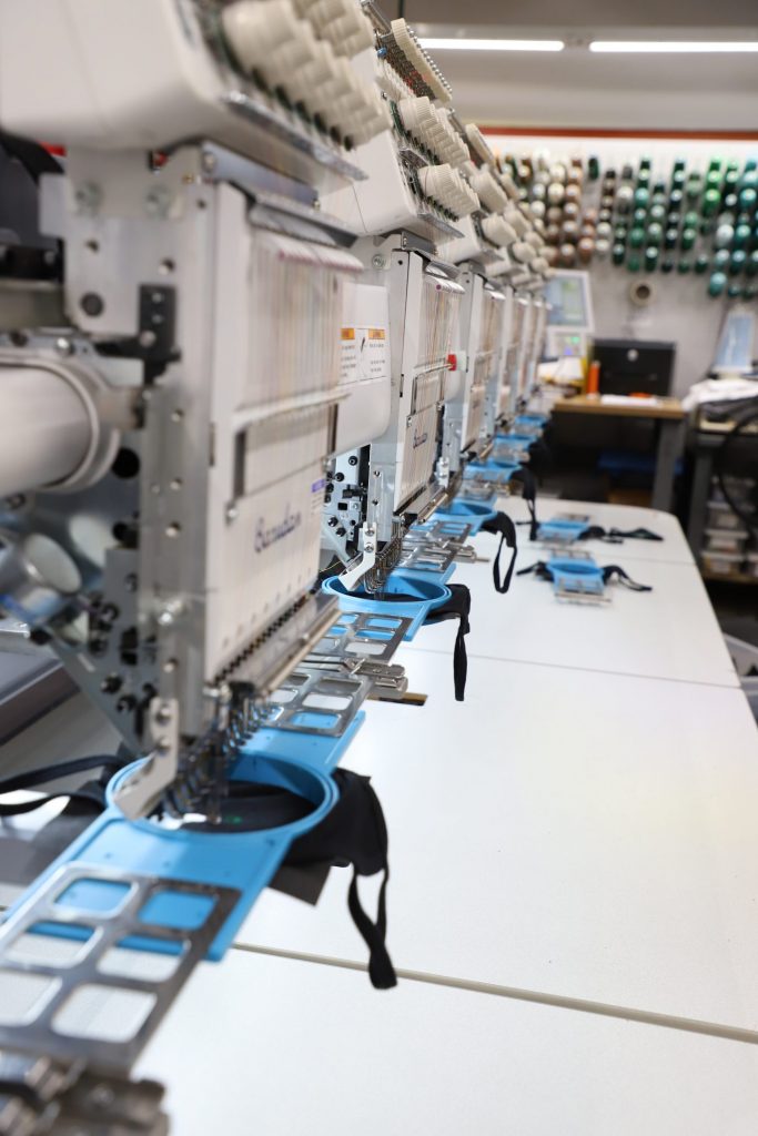 MOFF logo being embroidered on masks